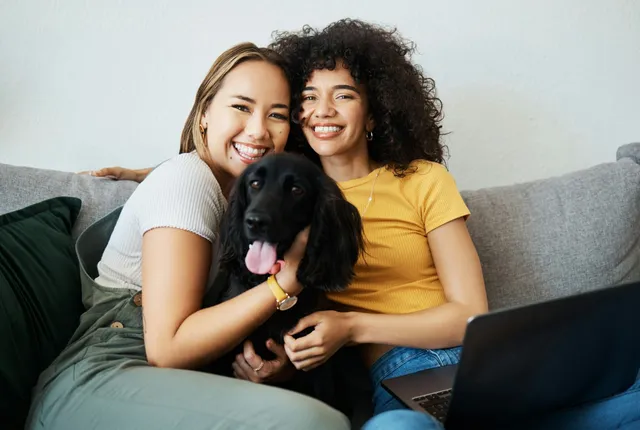 Happy couple relaxing at home with their dog