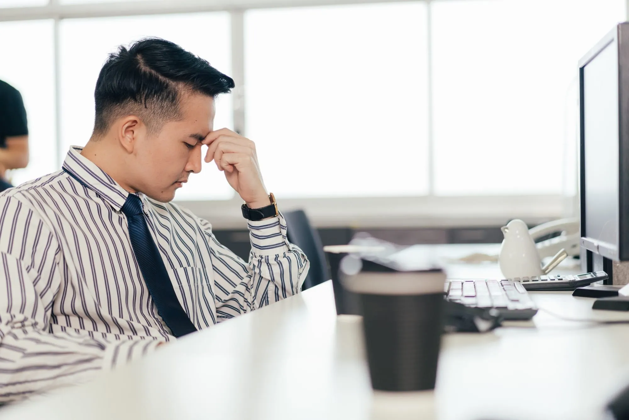 Stressed male employee feel pain eyestrain working on computer.